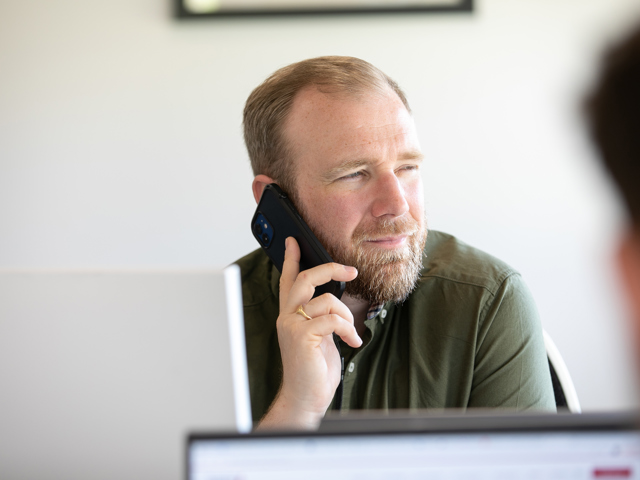 English man on phone at business recruitment desk 